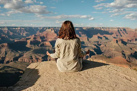 Person meditating on rock