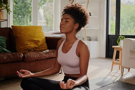 Woman meditating in house