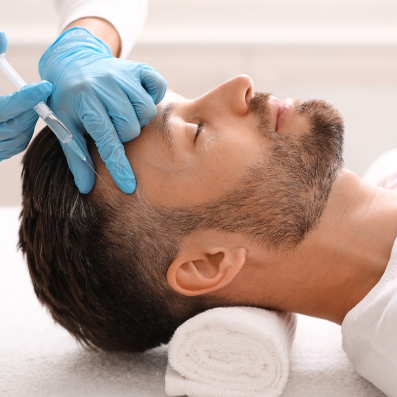 Man receiving  PRP Hair Restoration treatment